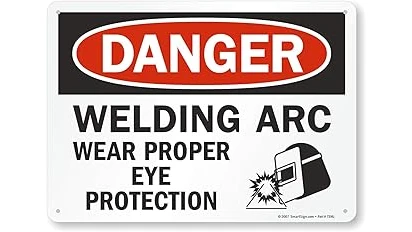 The image shows a neatly organized collection of essential personal protective equipment for a welding workspace.