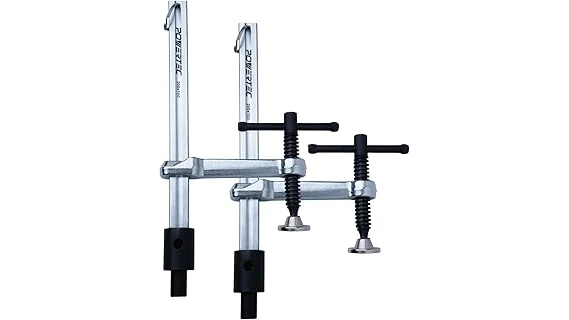 The image shows a collection of various welding table fixture clamps, essential for securing metal during fabrication.