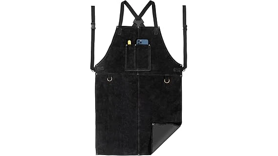 The image shows a person wearing a heavy-duty leather welding apron, showcasing quality craftsmanship for top welding aprons.