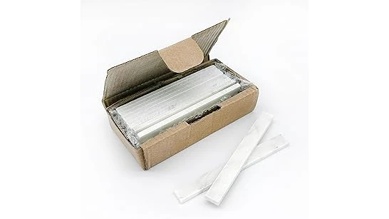 The image shows white soapstone pieces and marking tools for welding.