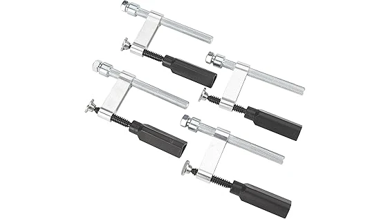 This image shows several robust welding table dog clamps with sturdy metal construction.