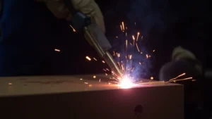The image shows a close-up of a welding arc, demonstrating how to set correct arc length in stick welding.