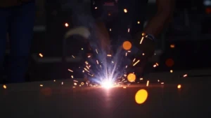 The image shows a close-up of a welding machine's digital display detailing Tig welder pulse settings.