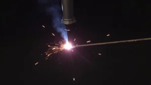 This image shows a close-up of a MIG welder's wire feeder mechanism for adjusting settings.