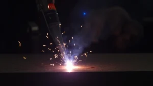 The image shows a Tig welding torch with gas flowing during proper setup for the procedure.