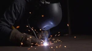 The image shows a close-up of a MIG welder wire feed roller, part of a solution for slow wire feeding.