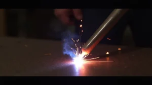 The image shows a stick welder electrode with poor penetration, indicating it's not melting metal properly.