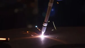 The image shows a close-up of a wire feeder mechanism for stick welding, illustrating problems solved.
