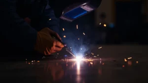 The image shows a close-up of a TIG welding torch creating a bead, illustrating common TIG welding mistakes to avoid.