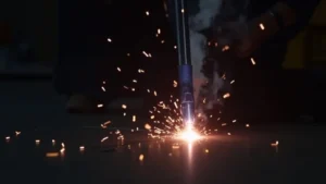 The image shows a close-up of a MIG welder wire feeder mechanism, illustrating potential issues with smooth wire feeding.