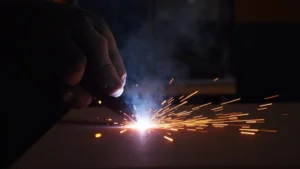 The image shows a stick welder producing a weak, sputtering arc, illustrating a common problem.