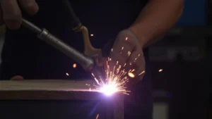 The image shows a close-up of a TIG welding torch with a disconnected power cable, suggesting a reason for arc issues.